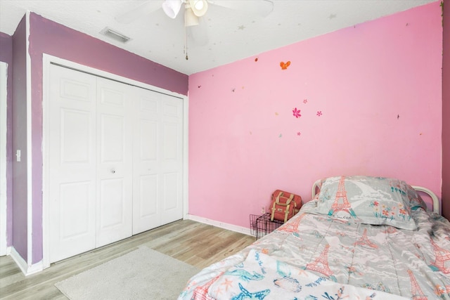 3372 9th St, Elkton, FL 32033 - bedroom featuring baseboards, a closet, wood finished floors, and visible vents
