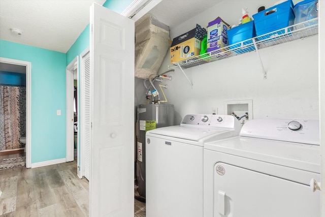 3372 9th St, Elkton, FL 32033 - laundry area with laundry area, baseboards, electric water heater, light wood-style flooring, and independent washer and dryer