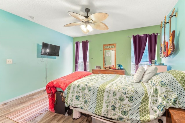 3372 9th St, Elkton, FL 32033 - bedroom featuring a ceiling fan, baseboards, multiple windows, and wood finished floors