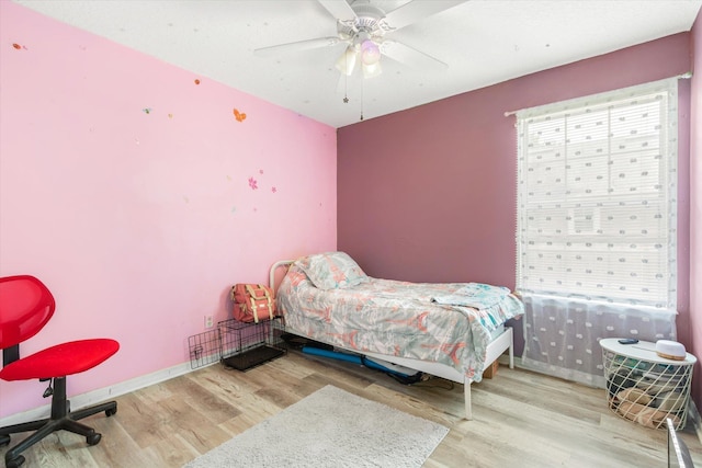3372 9th St, Elkton, FL 32033 - bedroom with baseboards, ceiling fan, and wood finished floors