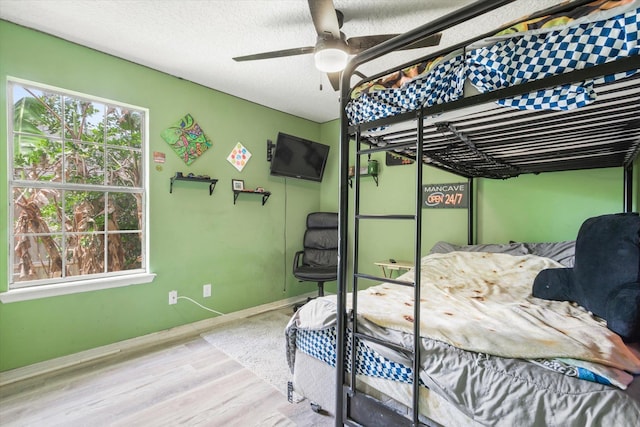 3372 9th St, Elkton, FL 32033 - bedroom featuring baseboards, a ceiling fan, and wood finished floors