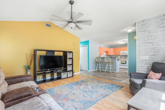 3372 9th St, Elkton, FL 32033 - living area featuring ceiling fan, visible vents, vaulted ceiling, baseboards, and light wood-style flooring