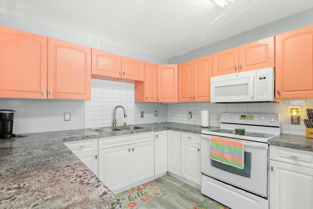 3372 9th St, Elkton, FL 32033 - kitchen featuring a sink, white appliances, a textured ceiling, light wood-style flooring, and tasteful backsplash