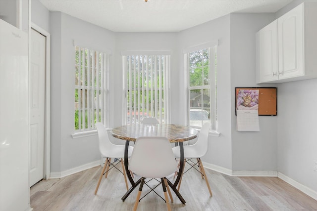 3372 9th St, Elkton, FL 32033 - dining area featuring baseboards and light wood-style flooring