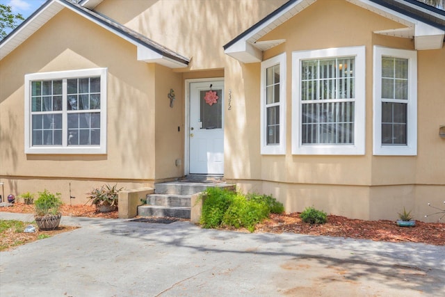 3372 9th St, Elkton, FL 32033 - property entrance featuring stucco siding and a patio area