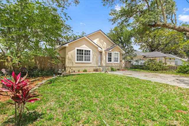 3372 9th St, Elkton, FL 32033 - bungalow with stucco siding, a front lawn, and fence