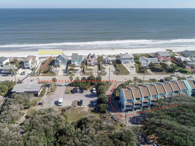 birds eye view of property featuring a water view and a beach view