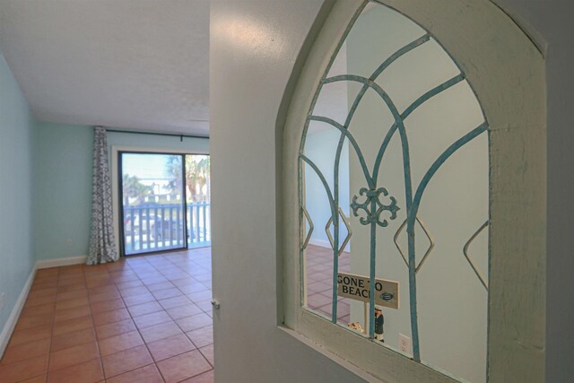 hallway with light tile patterned floors