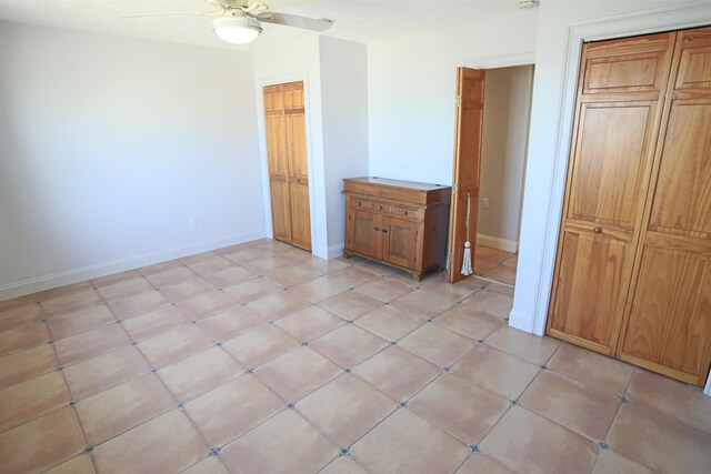 unfurnished bedroom featuring ceiling fan