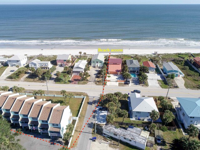 aerial view with a water view and a beach view