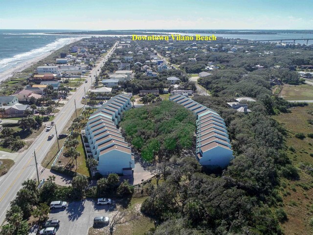 drone / aerial view featuring a water view and a beach view