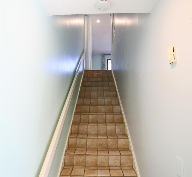 stairs with tile patterned floors