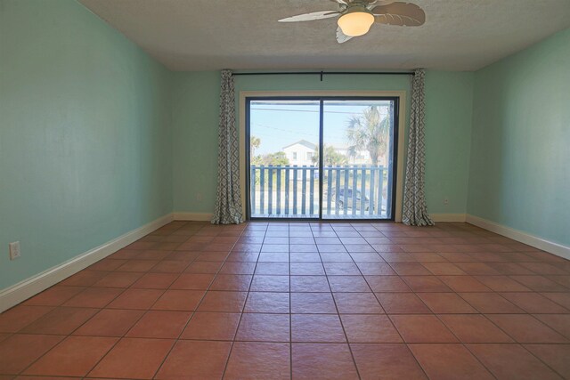 tiled spare room featuring ceiling fan and a textured ceiling