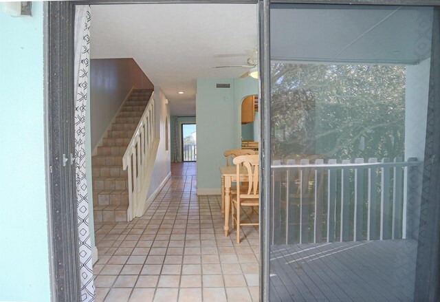 tiled foyer entrance featuring ceiling fan