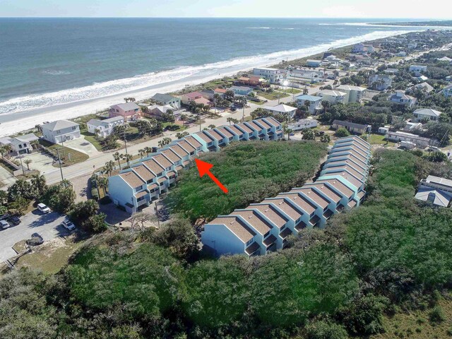 drone / aerial view featuring a beach view and a water view