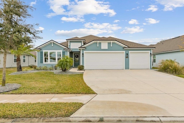 view of front of house featuring a garage and a front lawn