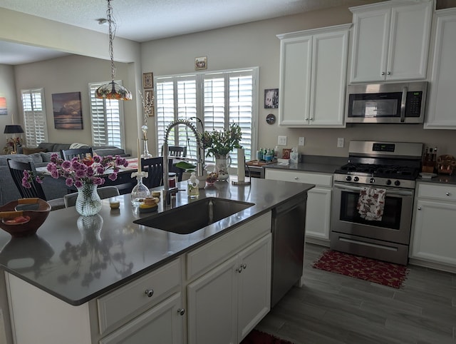 kitchen with white cabinets, dark hardwood / wood-style floors, sink, and stainless steel appliances