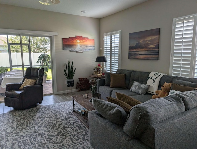 living room featuring wood-type flooring, a textured ceiling, and a wealth of natural light