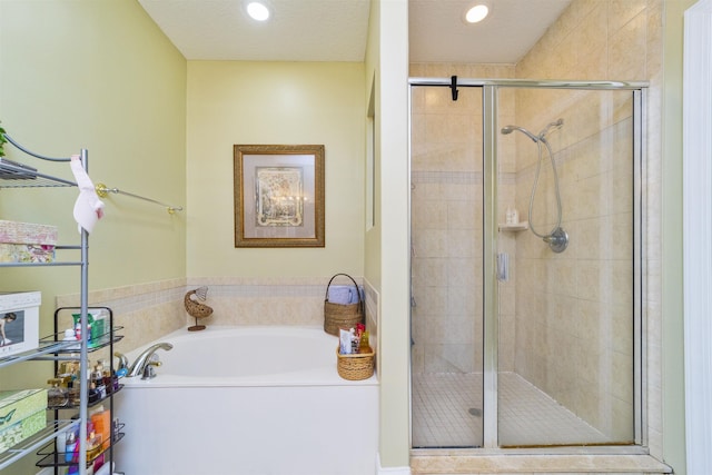 bathroom with separate shower and tub and a textured ceiling