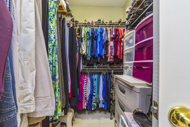 walk in closet with tile patterned floors