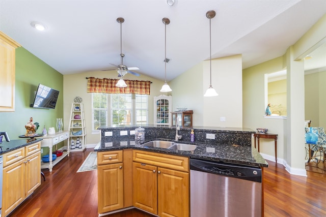 kitchen with dark stone counters, sink, vaulted ceiling, stainless steel dishwasher, and dark hardwood / wood-style flooring