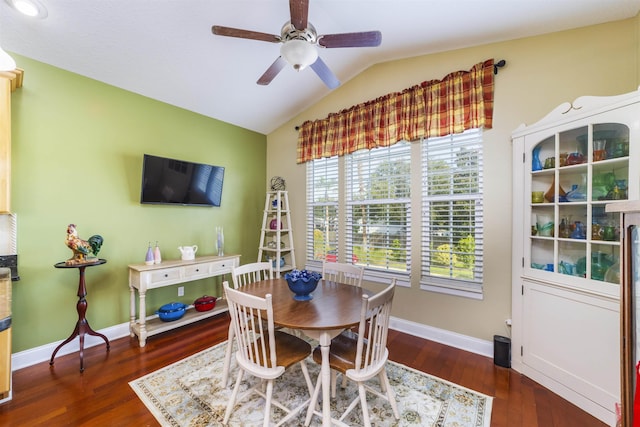 dining space with dark hardwood / wood-style flooring, vaulted ceiling, and ceiling fan