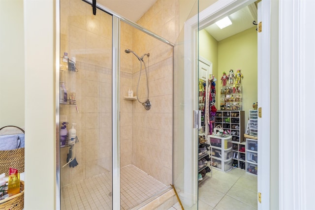 bathroom with tile patterned floors and a shower with door