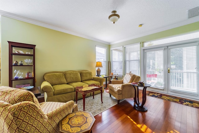 living room featuring a textured ceiling, dark hardwood / wood-style floors, and crown molding