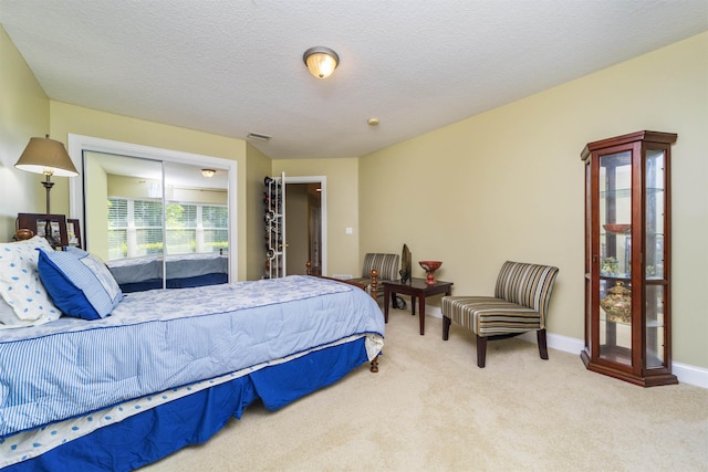 carpeted bedroom with a textured ceiling