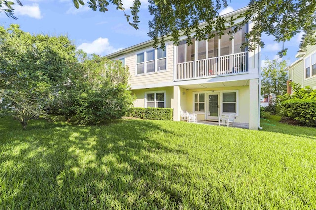 rear view of house with a lawn