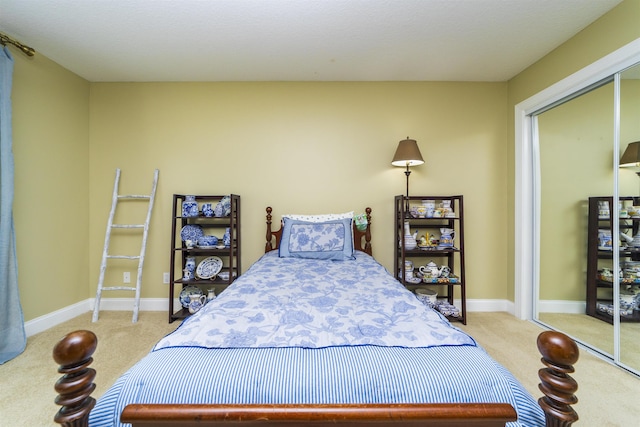 bedroom with light carpet and a closet