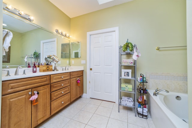 bathroom featuring tile patterned floors, a tub to relax in, and vanity