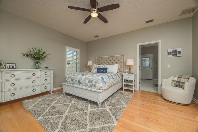 bedroom featuring ceiling fan, a textured ceiling, and hardwood / wood-style flooring