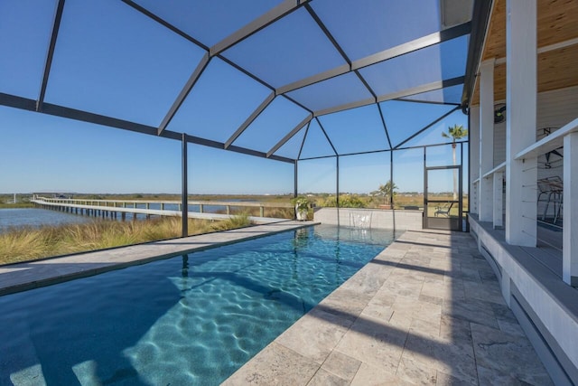 view of pool featuring a water view, a patio area, and a lanai