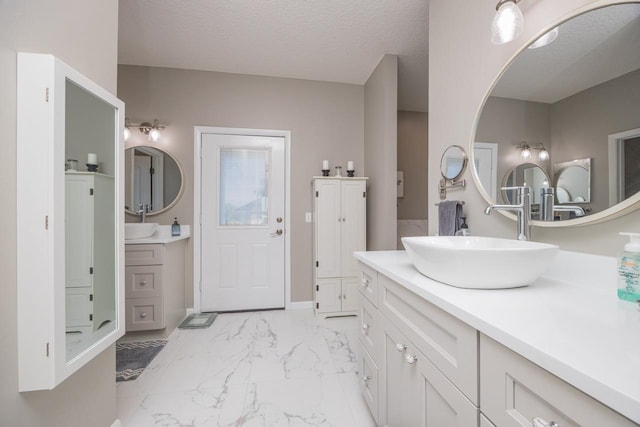 bathroom featuring vanity and a textured ceiling