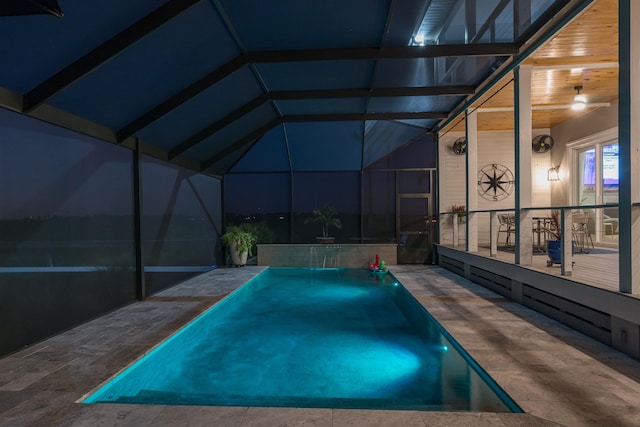 view of swimming pool featuring pool water feature, glass enclosure, and a patio