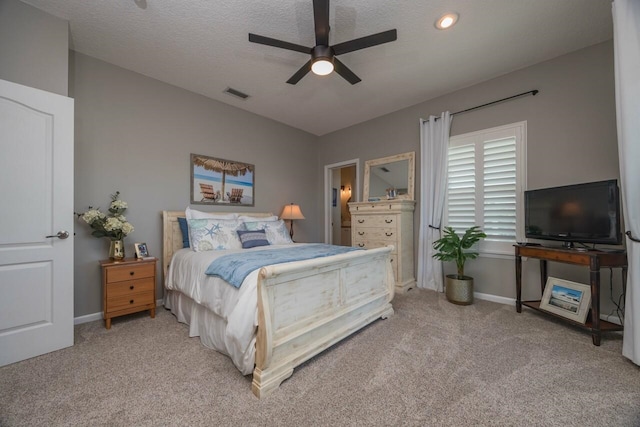 bedroom with ceiling fan, a textured ceiling, and light carpet