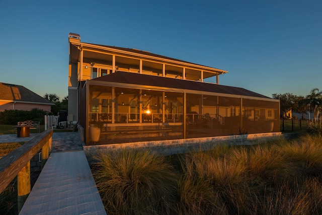 view of back house at dusk