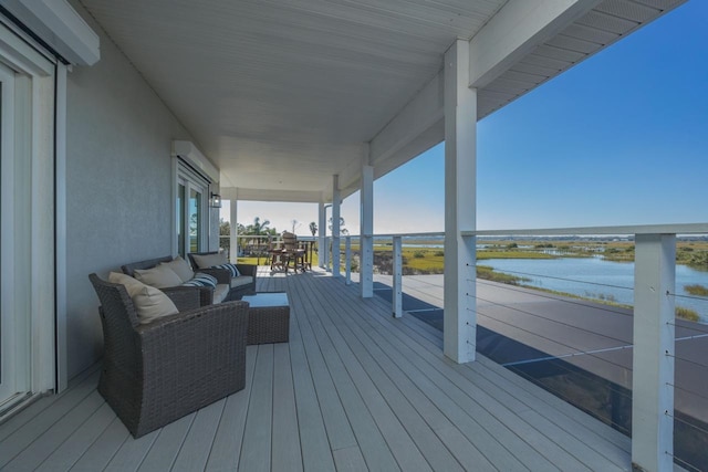 wooden deck featuring an outdoor living space and a water view