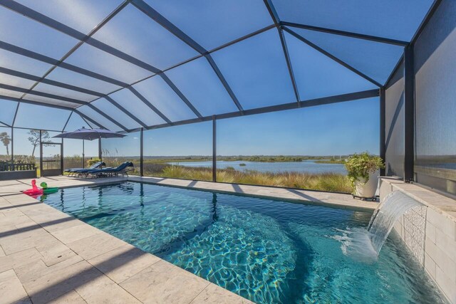 view of swimming pool featuring a lanai, pool water feature, a water view, and a patio