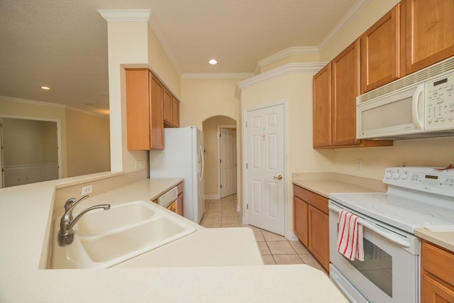 kitchen with white appliances, a textured ceiling, crown molding, sink, and light tile patterned floors