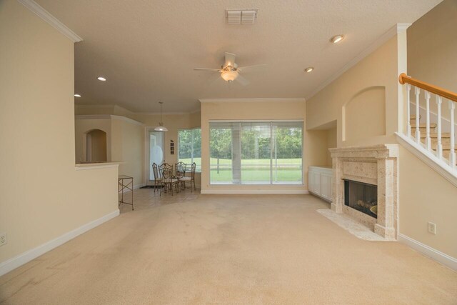 unfurnished living room with crown molding, light carpet, and a high end fireplace