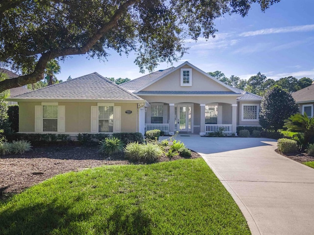 view of front of house with a porch and a front lawn