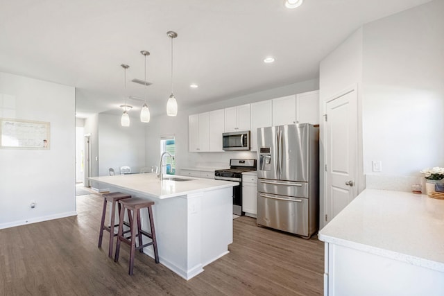 269 Clarys Run, Saint Augustine, FL 32092 - kitchen with appliances with stainless steel finishes, dark wood-type flooring, white cabinets, a breakfast bar, and recessed lighting