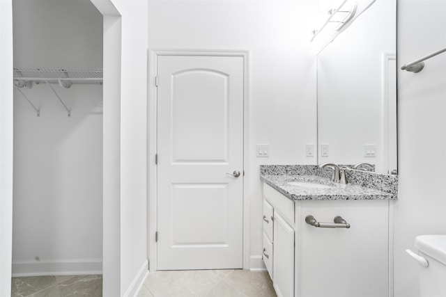272 Grand Ravine Dr, Saint Augustine, FL 32086 - bathroom featuring vanity, toilet, baseboards, and a spacious closet