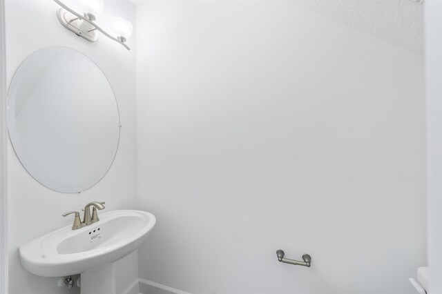 272 Grand Ravine Dr, Saint Augustine, FL 32086 - bathroom featuring a sink and baseboards