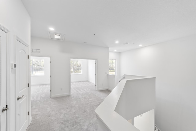 272 Grand Ravine Dr, Saint Augustine, FL 32086 - corridor with an upstairs landing, light carpet, recessed lighting, and baseboards