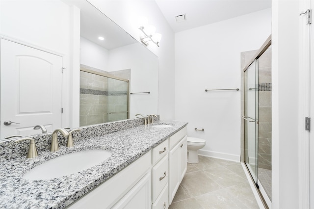 272 Grand Ravine Dr, Saint Augustine, FL 32086 - bathroom with double vanity, a shower stall, toilet, baseboards, and tile patterned flooring