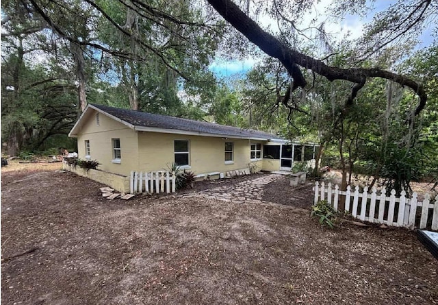 16325 SE 134th Ct, Weirsdale, FL 32195 - rear view of house featuring a sunroom and fence