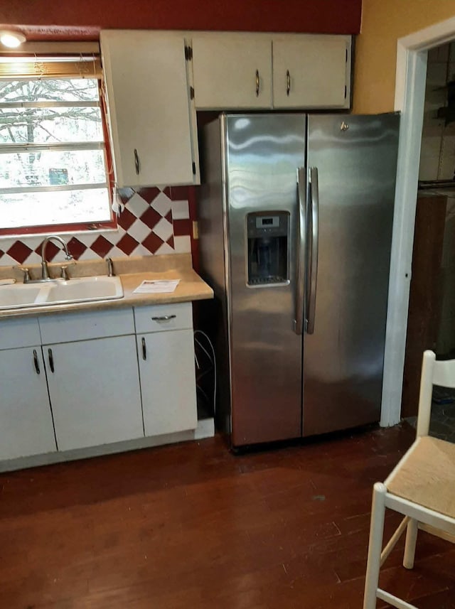 16325 SE 134th Ct, Weirsdale, FL 32195 - kitchen with stainless steel fridge, a sink, light countertops, backsplash, and white cabinets